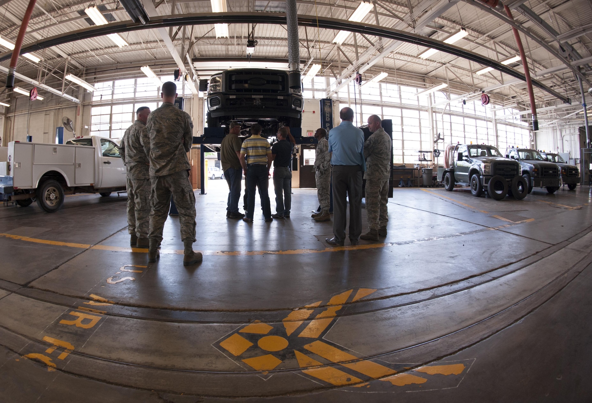 Robins Air Force Base engineers examine the bobtail while representatives from Dyess AFB and Arrow Ford gather to talk about modifications for the flightline tow tractor, also known as a bobtail vehicle, at Dyess AFB, Texas, June 14, 2017. If the modification is approved, the new I-beam will fit 1999 to present F-350 chassis; additionally, there is no modification needed for the vehicles except for the replacement twin I-beams which meet or exceed Original Equipment Manufacturer standards. (U.S. Air Force photo by Airman 1st Class April Lancto)