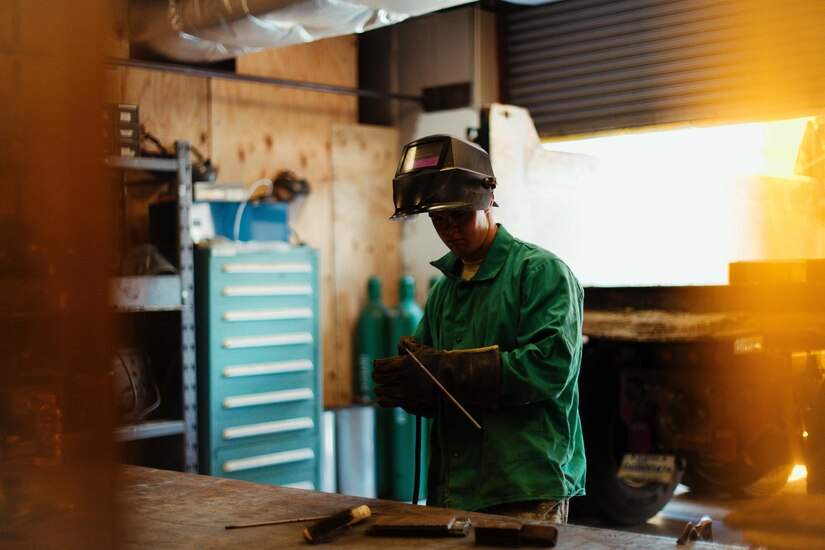 Airman 1st Class Hogan Lambeth, 11th Civil Engineer Squadron structural apprentice, prepares to weld a metal rod at Joint Base Andrews, Md., June 21, 2017. The 11th CES structures section works with metal and wood projects that focus on preventative maintenance and repairs throughout base. (U.S. Air Force photo by Senior Airman Delano Scott)  