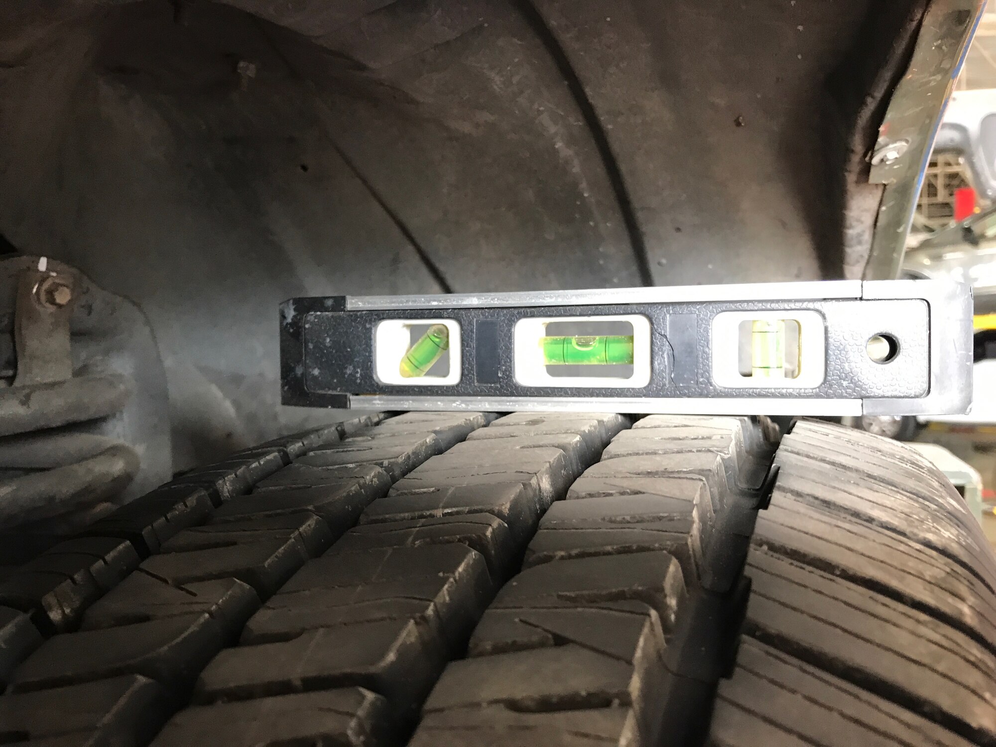 A level sits on top of a newly modified bobtail tire, which was developed by the 7th Logistics Readiness Squadron vehicle maintenance flight and Arrow Ford. This modification can align the tires properly with new twin I-beams and can save an estimated 2,200 man hours for vehicle repairs. (Courtesy photo)