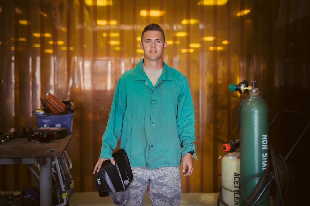 Airman 1st Class Hogan Lambeth, 11th Civil Engineer Squadron structural apprentice, poses for a photo in the metals technology shop at Joint Base Andrews, Md., June 21, 2017. The 11th CES structures section works with metal and wood projects that focus on preventative maintenance and repairs throughout base. (U.S. Air Force photo by Senior Airman Delano Scott)       