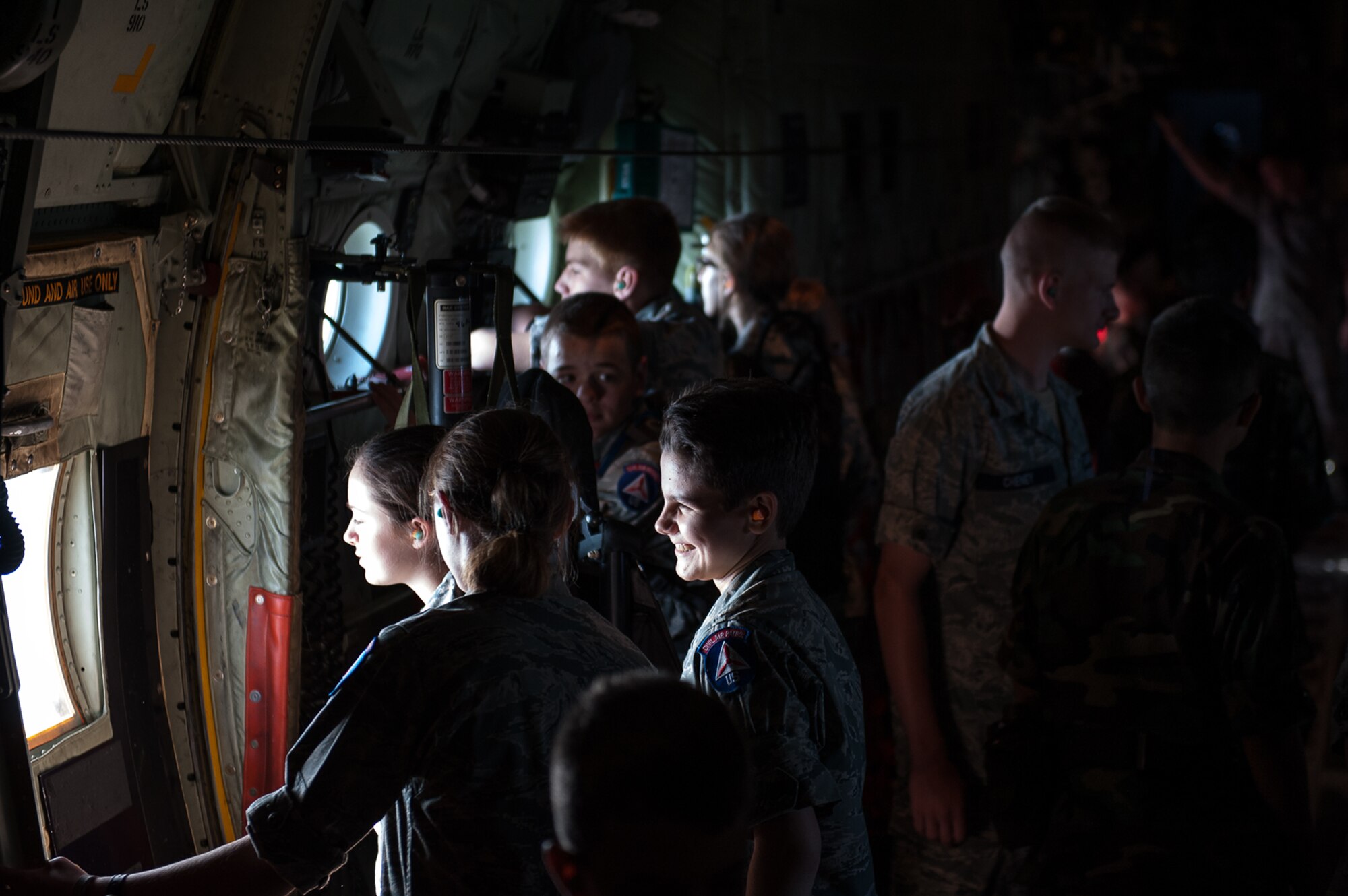 Civil Air Patrol cadets look out the windows of a C-130J Super Hercules assigned to the 37th Airlift Squadron on Ramstein Air Base, during a flight over Rheinland-Pfalz, Germany, June 20, 2017. The 37th AS conducted the flight so cadets could learn about the aircraft first-hand. (U.S. Air Force photo by Senior Airman Devin Boyer)