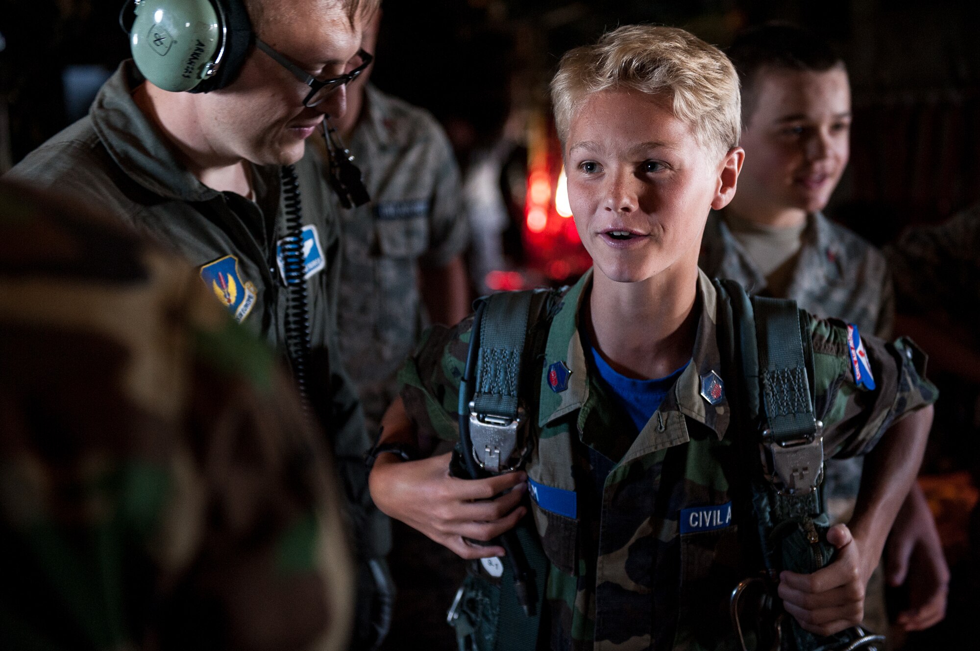 Civil Air Patrol Cadet Master Sgt. John Odom, Ramstein Cadet Squadron, tries on a parachute pack aboard a C-130J Super Hercules assigned to the 37th Airlift Squadron on Ramstein Air Base, during a flight over Rheinland-Pfalz, Germany, June 20, 2017. The flight gave cadets the chance to learn about operations on the aircraft which could potentially be a career path they may take one day. (U.S. Air Force photo by Senior Airman Devin Boyer)