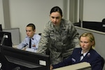 1st Lt Victoria Rathbone, 33rd Network Warfare Squadron, provides one-on-one training to a pair of Civil Air Patrol cadets during the 2017 Cyber Defense Training Academy June 11, 2017, at Joint Base San Antonio-Lackland, Texas. More than 100 cadets attended the fourth iteration of the national CAP cyberspace training program.