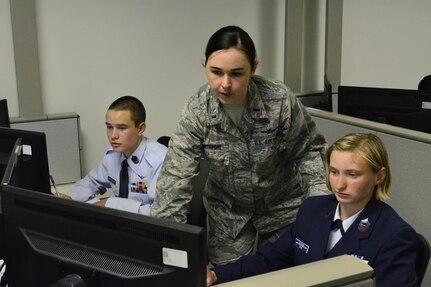 1st Lt Victoria Rathbone, 33rd Network Warfare Squadron, provides one-on-one training to a pair of Civil Air Patrol cadets during the 2017 Cyber Defense Training Academy June 11, 2017, at Joint Base San Antonio-Lackland, Texas. More than 100 cadets attended the fourth iteration of the national CAP cyberspace training program.