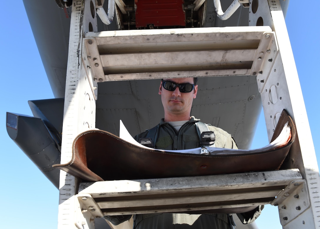 U.S. Air Force Lt. Col. “TAB,” 337th Test and Evaluations Squadron pilot, completes a form inspection prior to a flight at Nellis Air Force Base, Nev., June 13, 2017. Pilots conduct an equipment, aircraft and forms check prior to every flight. (U.S. Air Force photo by Senior Airman Shannon Hall)