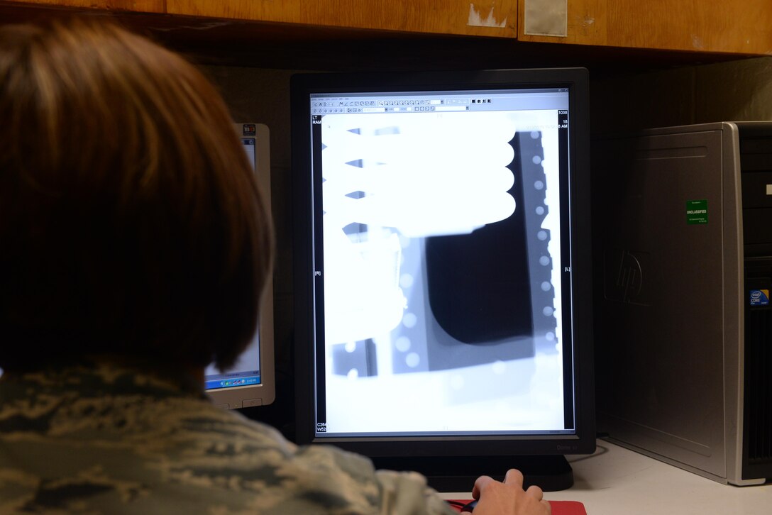U.S. Air Force Tech. Sgt. Joanna Peacock, 7th Equipment Maintenance Squadron nondestructive inspection shift lead, examines an aircraft part using the lab’s new computed radiography scanner at Dyess Air Force Base, Texas, June 15, 2017. With the new piece of equipment, the NDI lab is able to scan items faster and more reliably than with the previous film radiography scanner. Where the older method could take up to a couple hours, the computed radiography scanner takes only half an hour for most parts that the lab inspects. (U.S. Air Force photo by Airman 1st Class Rebecca Van Syoc)