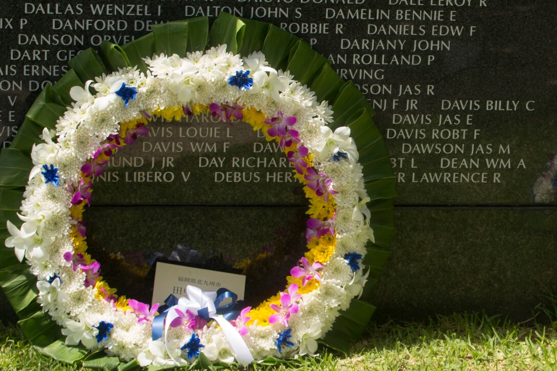 A wreath leans up against the Cornerstone of Peace memorial wall during the 2017 Okinawa Memorial Day services at Peace Memorial Park, Itoman, Japan, June 23, 2017. Marine Corps photo by Lance Cpl. Charles Plouffe
