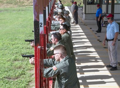 Weapons qualification course students fire their Beretta M9 pistols during the range portion of their training July 6, 2015, at the Joint Base San Antonio-Lackland Medina Annex. During this portion, students practice both kneeling and standing firing positions and record the accuracy of their hits with combat arms instructors to verify their weapon competency. The weapons qualification course is part of the Combat Arms Training and Maintenance program that introduces basic firearm safety and use practices for Airmen in Air Force Basic Military Training and refreshes that training for JBSA members deploying or undergoing a permanent change of station.