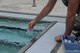 Airman 1st Class Michael Mannarino, 14th Medical Operations Squadron Bioenvironmental Technician, fills a vial with pool water June 21, 2017, at Columbus Air Force Base, Mississippi. The Bioenvironmental Flight test the base pool to ensure it is safe to swim. (U.S. Air Force photo by Airman 1st Class Beaux Hebert)