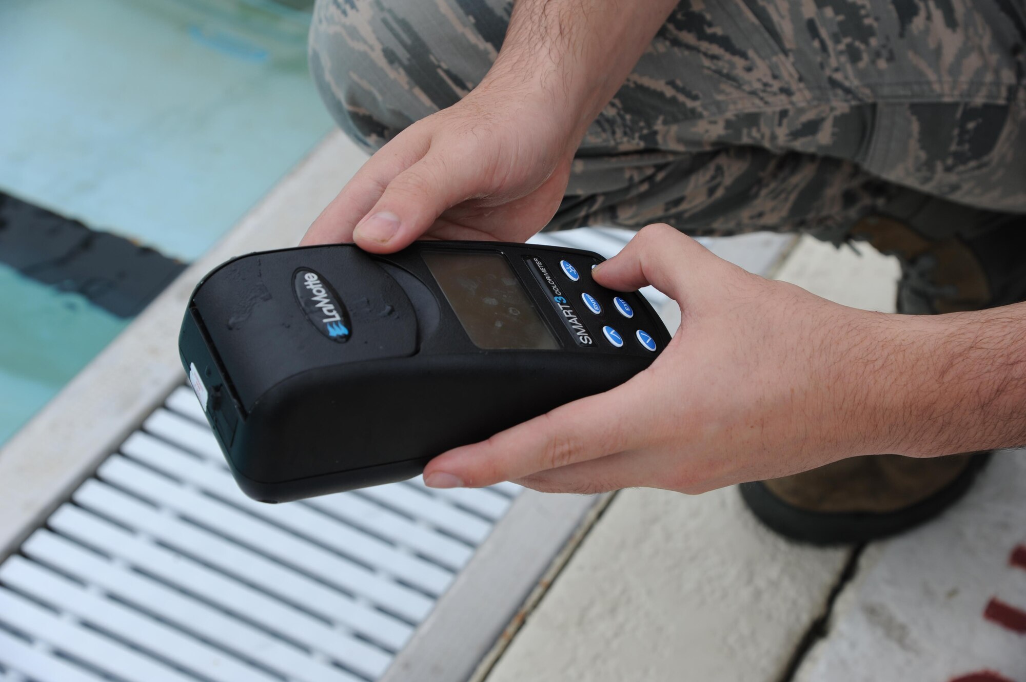 Airman 1st Class Michael Mannarino, 14th Medical Operations Squadron Bioenvironmental Technician, uses a device to test the chlorine levels in the base pool June 21, 2017, at Columbus Air Force Base, Mississippi. Mannarino has to test different areas in the pool to come up with an average chlorine level. (U.S. Air Force photo by Airman 1st Class Beaux Hebert)