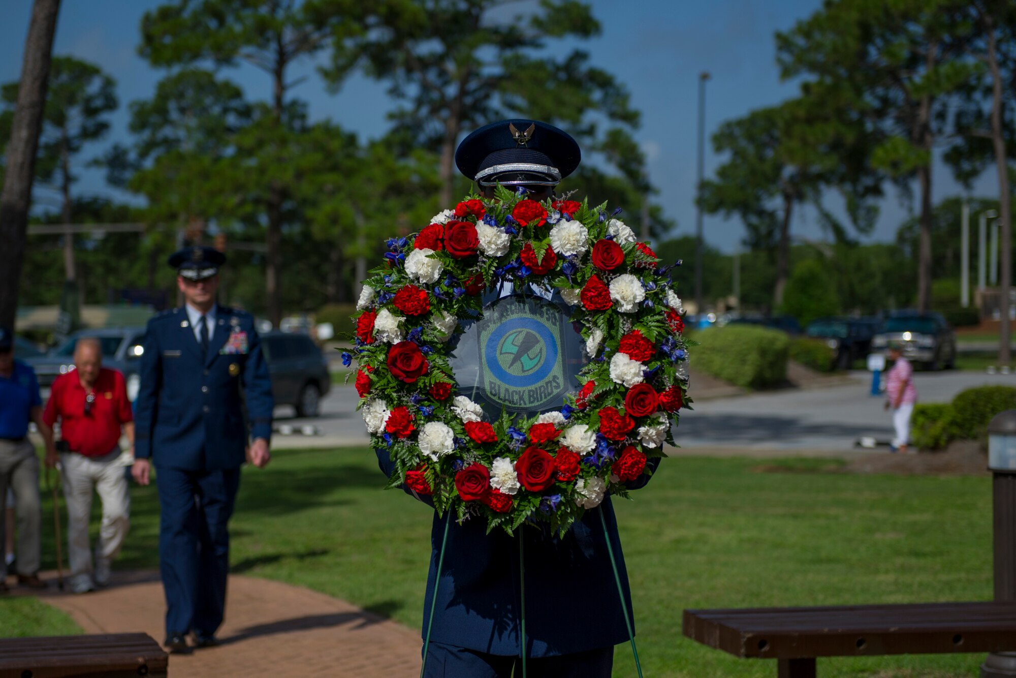 A member of the Hurlburt Field Honor Guard carries a wreath to the Operation Eagle Claw memorial ceremony at Hurlburt Field, Fla., June 23, 2017. Operation Eagle Claw was an attempted hostage-rescue mission in 1980 that resulted in five 8th Special Operations Squadron Airmen and three Marines sacrificing their lives when two of the involved aircraft collided at the Desert One staging site. (U.S. Air Force photo by Staff Sgt. Victor J. Caputo)