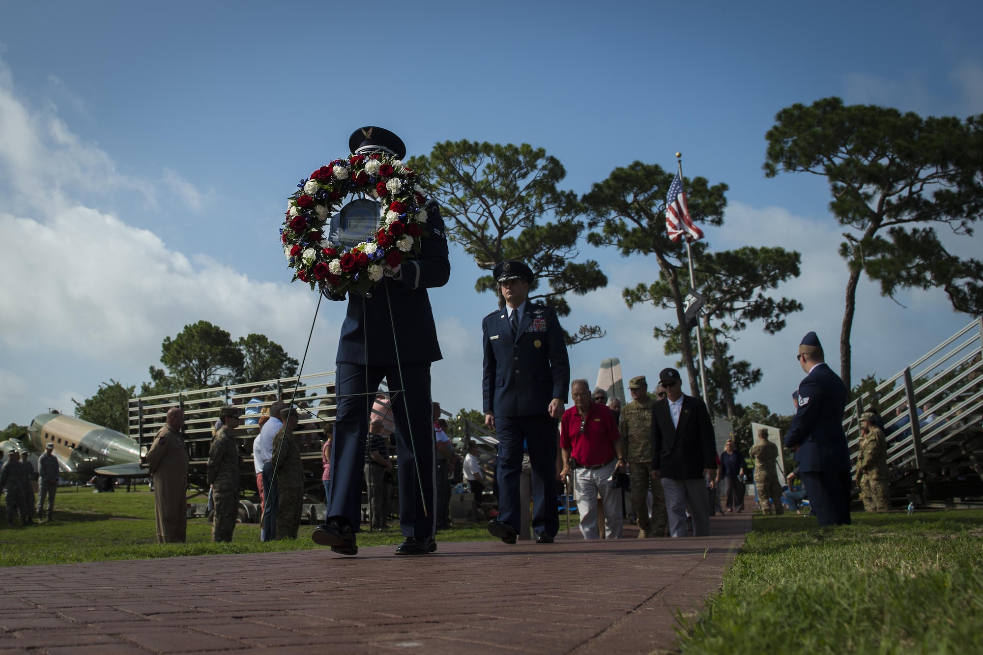 A member of the Hurlburt Field Honor Guard carries a wreath during the Operation Eagle Claw memorial ceremony at Hurlburt Field, Fla., June 23, 2017. Operation Eagle Claw was an attempted hostage-rescue mission in 1980. The mission resulted in five, 8th Special Operations Squadron Airmen and three Marines sacrificing their lives when two of the involved aircraft collided at the Desert One staging site. (U.S. Air Force photo by Airman 1st Class Joseph Pick)