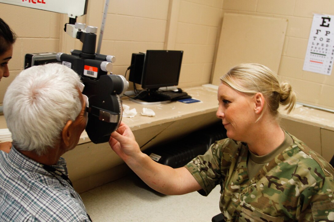 Maj. Jennifer Meadows, a U.S. Army Reserve Optometrist assigned to the 7226 Medical Support Unit, Fort Jackson, S.C., conducts an eye examination on Cornelio Reyes, a local resident of El Cenizo, Texas so he can receive a new free pair of glasses during the Joint Texas A&M Colonias Innovative Readiness Training designed to train Soldiers and provide free medical, dental and optometric care to low income residents in the border regions of Web County, Texas 19-29 June 2017. (U.S. Army Reserve photo by Cpt. Joe Bush 215th Mobile Public Affairs Detachment.)