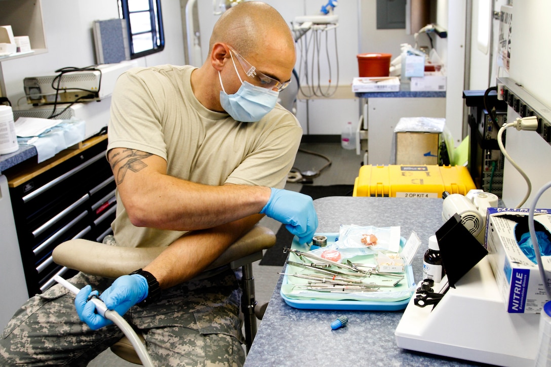 Sgt. Justin Miles, U.S. Army Reserve a dental technician, assigned to the 7226 Medical Support Unit, Fort Jackson, S.C., preps his station while assisting in dental procedures for the local residents of El Cenizo, Texas during the Joint Texas A&M Colonias Innovative Readiness Training designed to train Soldiers and provide free medical, dental and optometric care to low income residents in the border regions of Web County, Texas 19-29 June 2017. (U.S. Army Reserve photo by Cpt. Joe Bush 215th Mobile Public Affairs Detachment.)