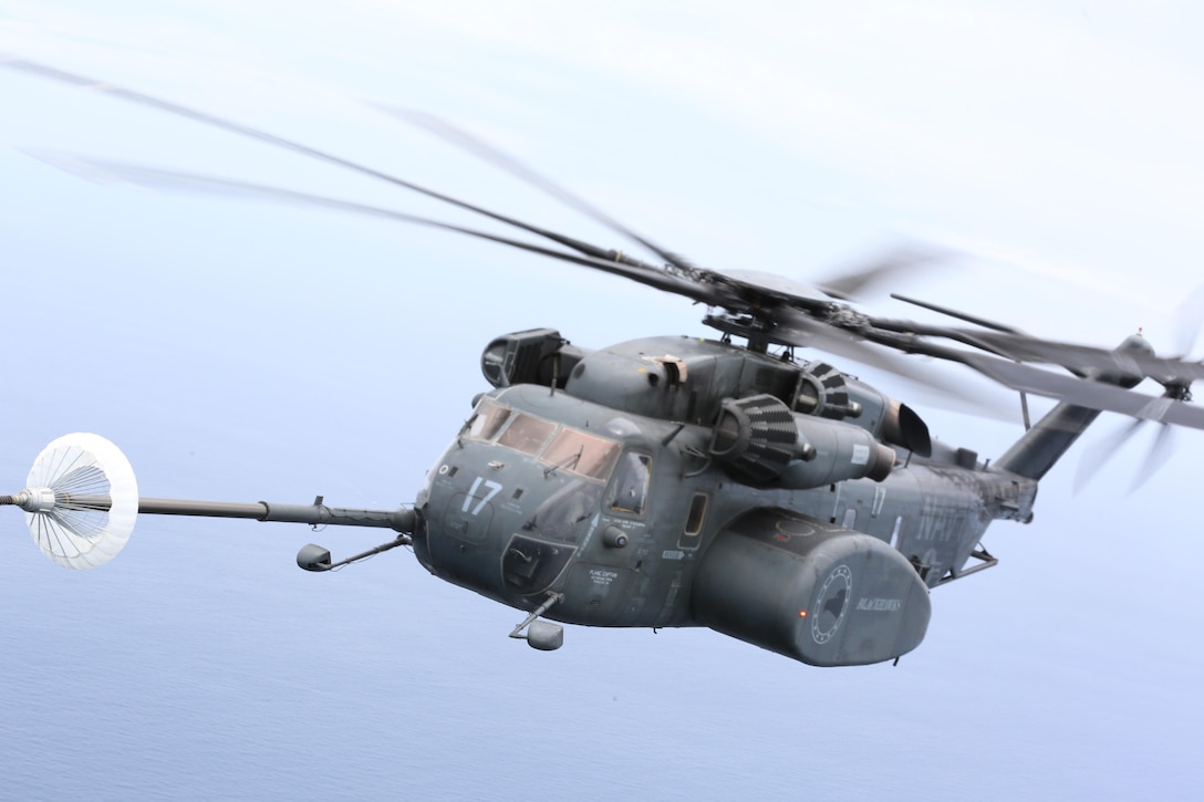 A U.S. Navy MH-53E Sea Dragon refuels during a joint training aerial refueling exercise near Marine Corps Air Station Cherry Point, N.C., June 21, 2017. A U.S. Marine Corps KC-130J Super Hercules assigned to Marine Aerial Refueler Transport Squadron 252, refueled four helicopters during the exercise. Joint training exercises such as this allow pilots to gain experience and improve unit readiness. The squadron is assigned to Marine Aircraft Group 14, 2nd Marine Aircraft Wing; and the four Navy aircraft are assigned to Helicopter Mine Countermeasures Squadron 14 and 15, Naval Air Force Atlantic, based at Naval Station Norfolk, Virginia. (U.S. Marine Corps photo by Pfc. Skyler Pumphret/ Released)