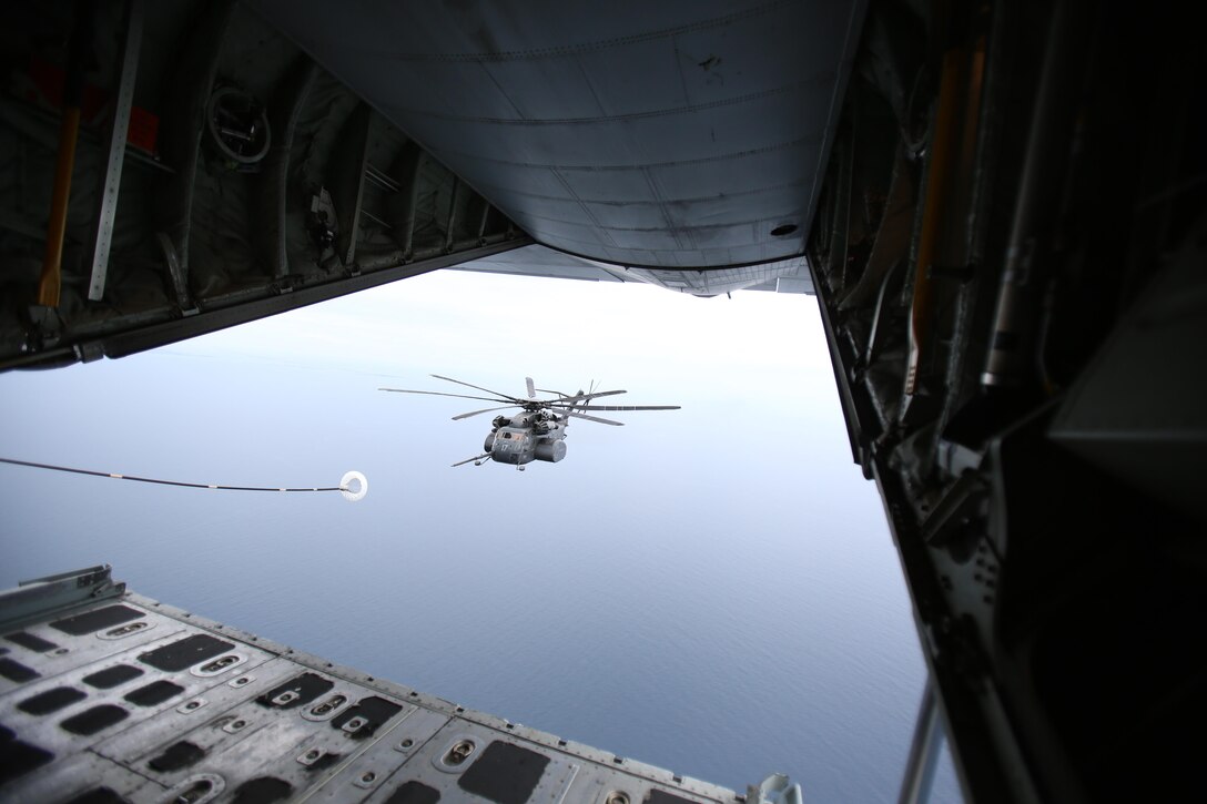 A U.S. Navy MH-53E Sea Dragon positions itself for refueling from a U.S. Marine Corps KC-130J Super Hercules during a joint refueling traning exericse near Marine Corps Air Station Cherry Point, N.C., June 21, 2017. Joint training exercises such as this allow pilots to gain experience and improve unit readiness. The KC-130J is assigned to Marine Aerial Refueler Transport Squadron 252, Marine Aircraft Group 14, 2nd Marine Aircraft Wing; and the Navy helicopter is from Helicopter Mine Countermeasures Squadron 14, Naval Air Force Atlantic, based at Naval Station Norfolk, Virginia. (U.S. Marine Corps Photo by Pfc. Skyler Pumphret/ Released)