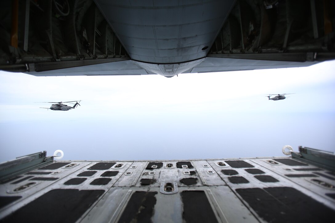 Two U.S. Navy MH-53E Sea Dragon helicopters follow a U.S. Marine Corps KC-130J Super Hercules during a joint aerial refueling exercise near Marine Corps Air Station Cherry Point, N.C., June 21, 2017. Joint training exercises such as this allow pilots to gain experience and improves unit readiness. The KC-130J is assigned to Marine Aerial Refueler Transport Squadron 252, Marine Aircraft Group 14, 2nd Marine Aircraft Wing; and the MH-53E’s are with Helicopter Mine Countermeasures Squadron 14 and 15, Naval Air Force Atlantic, from Naval Station Norfolk, Virginia.(U.S. Marine Corps photo by Pfc. Skyler Pumphret/ Released)