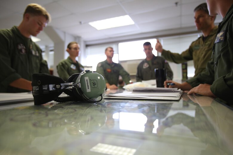 Servicemembers with Marine Aerial RefuelerTransport Squadron 252, Marine Air Group 14, 2nd Marine Aircraft Wing hold a preflight briefing for an Aerial Refuelling exercise June 21, 2017. Marines, sailors and a Royal Canadian Air Force pilot with the Marine Corps Foriegn Personnel Exchange Program took part in the exercise whith Navy MH-53 helicopters from Norfolk, Va. the exercise began with a KC-130J Super Hercules taking off from Cherry Point and flying north up the coast to rendezvous with the helicopters and then flying south to refuel the aircraft. (U.S. Marine Corps Photo by Pfc. Skyler Pumphret)