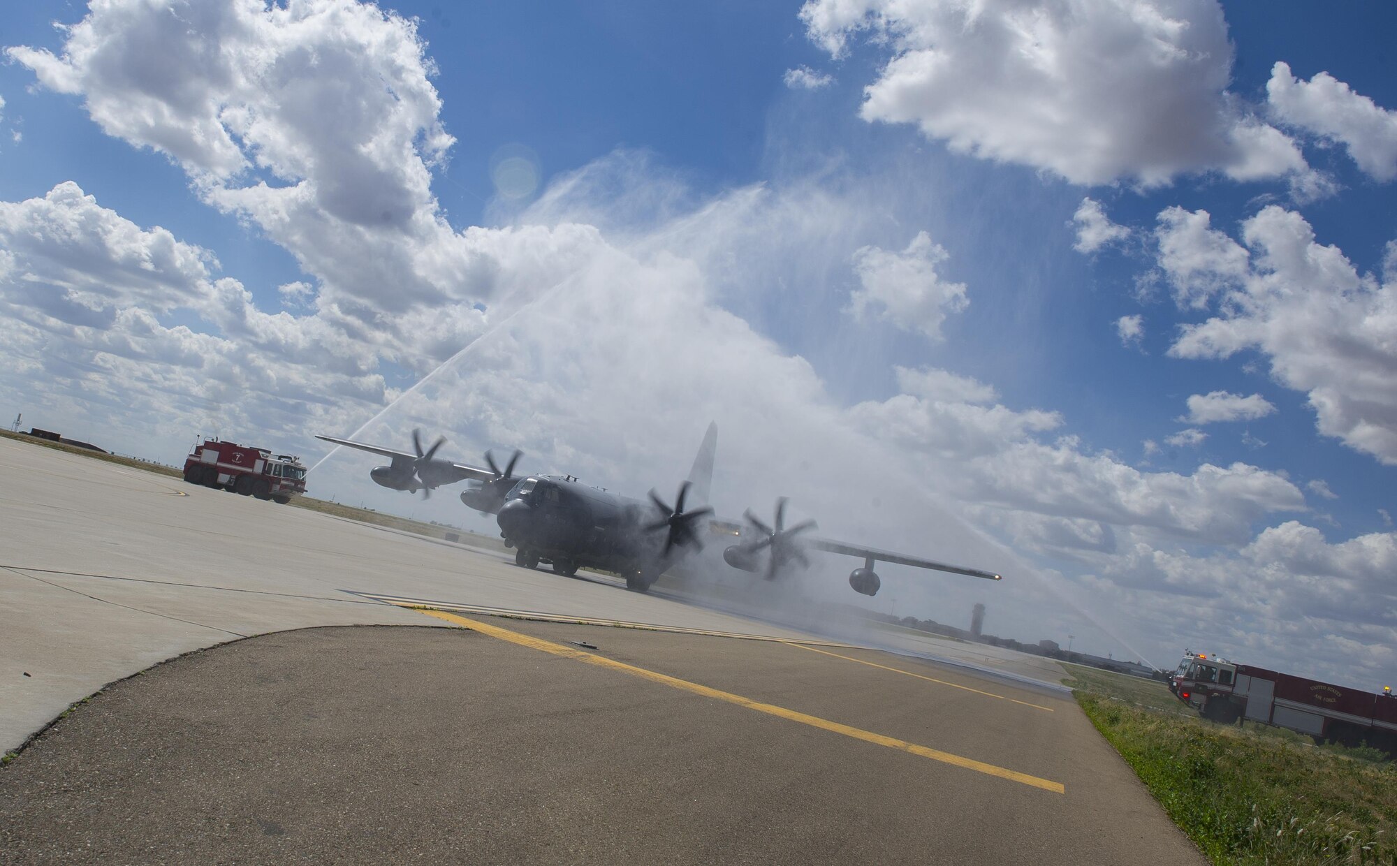 A MC-130J Commando II is sprayed by firetrucks, known as a “water salute,” as it taxis on the flightline during the ‘fini flight’ of its pilot, Col. Benjamin Maitre, former 27th Special Operations Wing commander, at Cannon Air Force Base, New Mexico, Jun. 1, 2017. The tradition of spraying plumes of water over aircraft can signal the end of the pilot’s career there or mark the beginning or end of the aircraft’s life. Dating back to World War II, the U.S. military has celebrated pilots’ and other experienced officers’ final flights either at their current unit or their career. Pilots use these celebrations as another opportunity to help train accompanying Airmen on their roles aboard the aircraft to ensure mission readiness. (U.S. Air Force photo by Senior Airman Lane T. Plummer)