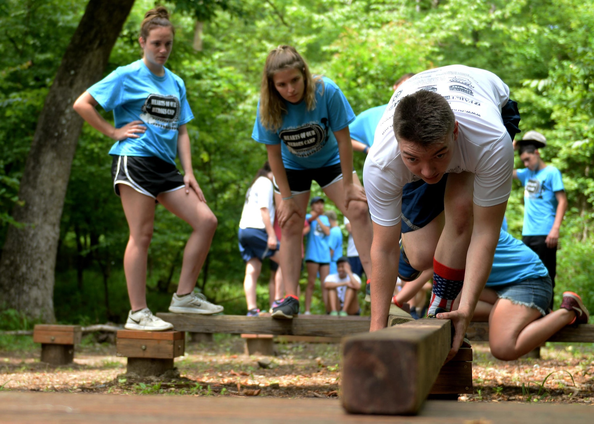 Airman 1st Class Dakotastorm Nichols, 19th Security Forces entry controller, builds a platform with Gold Star children during a team building exercise June 15, 2017, at the Hearts of Our Heroes camp in Little Rock, Ark. Hearts of Our Heroes camp offers an opportunity for Gold Star children to come together as a community and help one another through difficult times. (U.S. Air Force Photo by Airman 1st Class Codie Collins) 