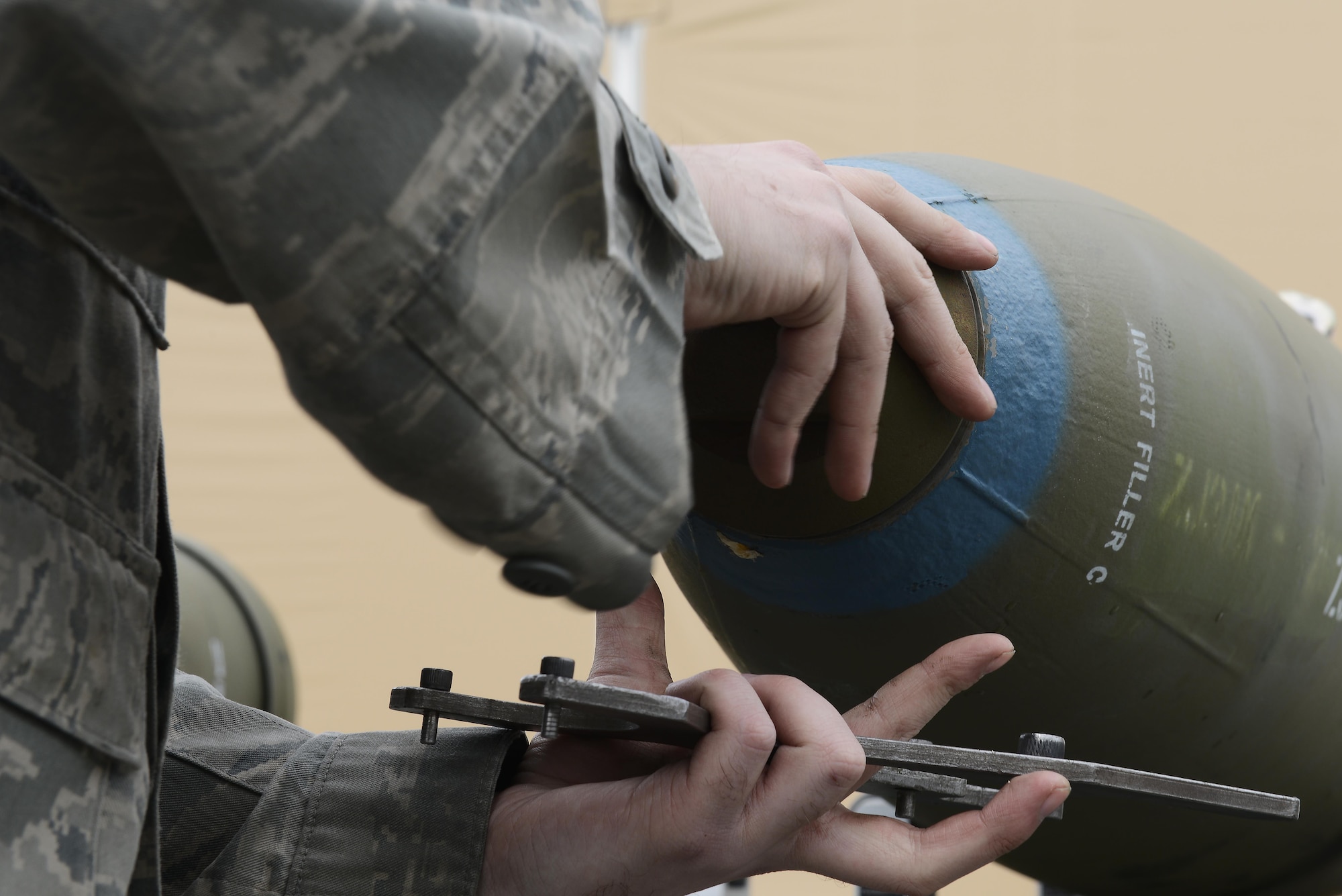 Senior Airman Nathan Coorough, a conventional maintenance technician with the 3rd Munitions Squadron, attaches a nose cap to a Joint Direct Attack Munition Guided Bomb Unit during a bomb build on Joint Base Elmendorf-Richardson, Alaska, June 19, 2017. Bomb builds provide training and certification for 230 personnel within 3rd MUNS and keeps the squadron compliant, lethal and ready.