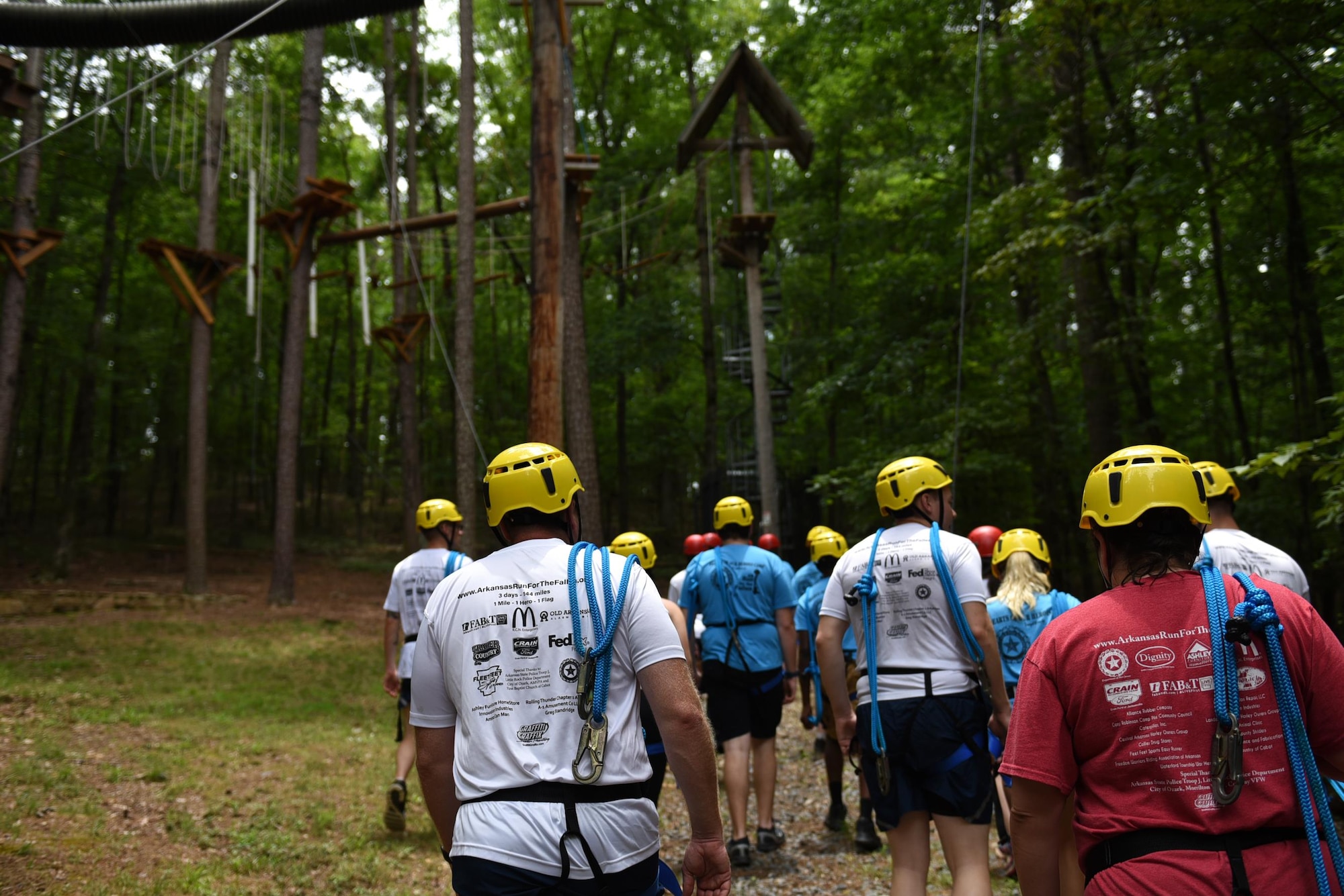 Gold Star children and U.S. Air Force volunteers walk to an obstacle course June 15, 2017, at the Hearts of Our Heroes Camp in Little Rock, Ark. Children ages 9 through 17 participated in different activities such as concerts, obstacle courses and team building exercises. (U.S. Air Force photo by Airman 1st Class Kevin Sommer Giron)