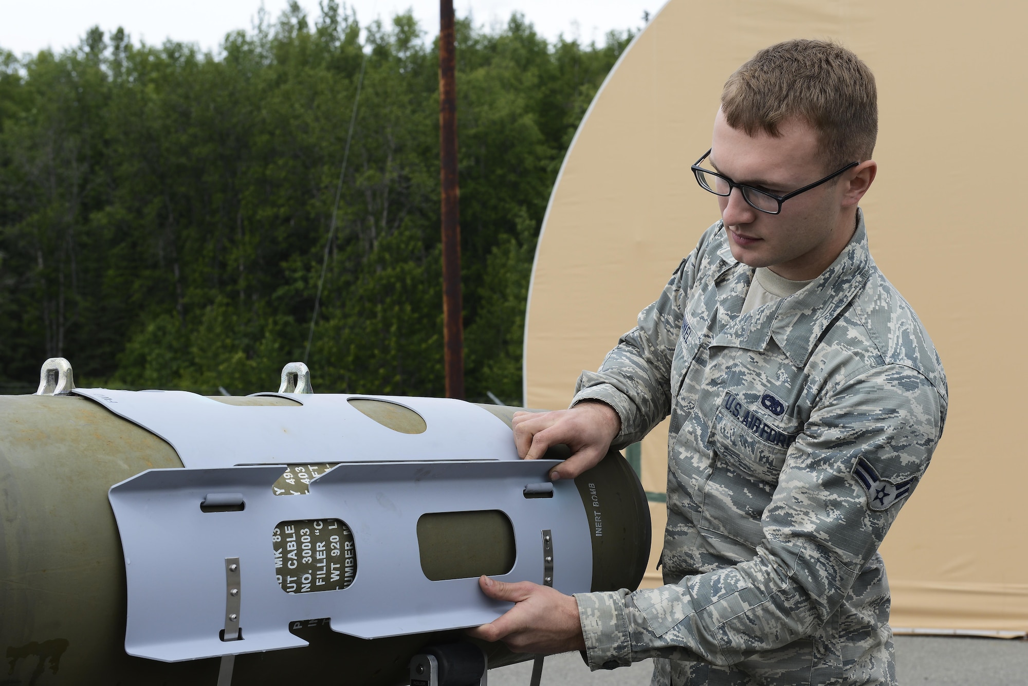 Airman 1st Class Carl Runkel, a conventional maintenance technician with the 3rd Munitions Squadron, builds a Joint Direct Attack Munition Guided Bomb Unit during a bomb build on Joint Base Elmendorf-Richardson, Alaska, June 19, 2017. Bomb builds provide training and certification for 230 personnel within 3rd MUNS and keeps the squadron compliant, lethal and ready.