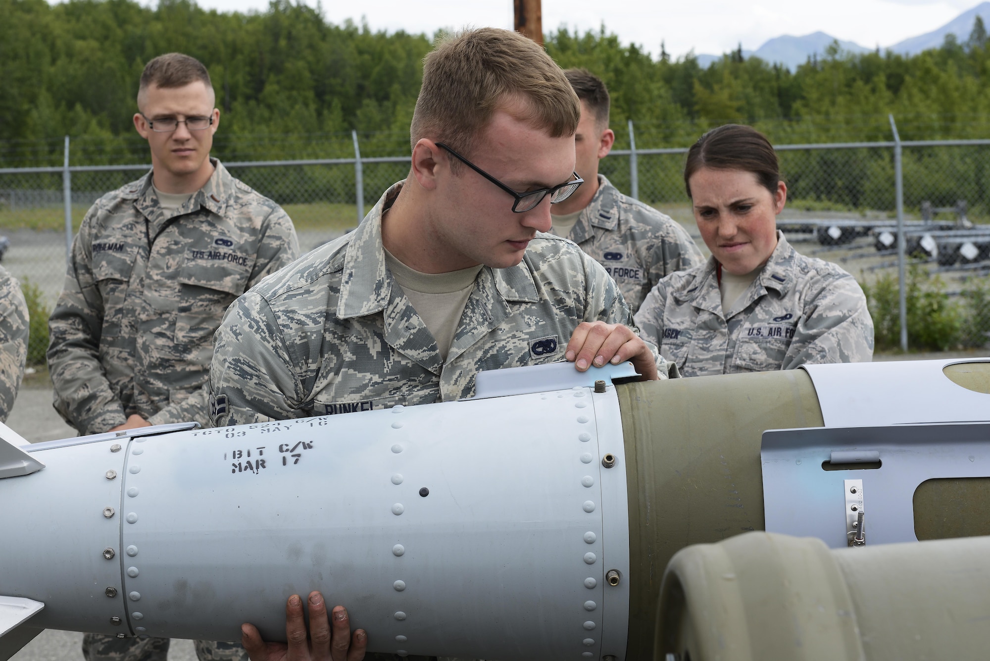 Airman 1st Class Carl Runkel, a conventional maintenance technician with the 3rd Munitions Squadron, builds a Joint Direct Attack Munition Guided Bomb Unit during a bomb build on Joint Base Elmendorf-Richardson, Alaska, June 19, 2017. Bomb builds provide training and certification for 230 personnel within 3rd MUNS and keeps the squadron compliant, lethal and ready. 