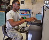 Senior Airman Xavier Green, a 919th Special Operations Maintenance Squadron aircraft ground equipment journeyman, uses a TEREX program to conduct an acceptance inspection on a portable floodlight cart at Duke Field, Fla.  The squadron's AGE flight provides fully mission capable AGE equipment to support all Duke aircraft and civil engineering requirements. (U.S. Air Force photo/Dan Neely)