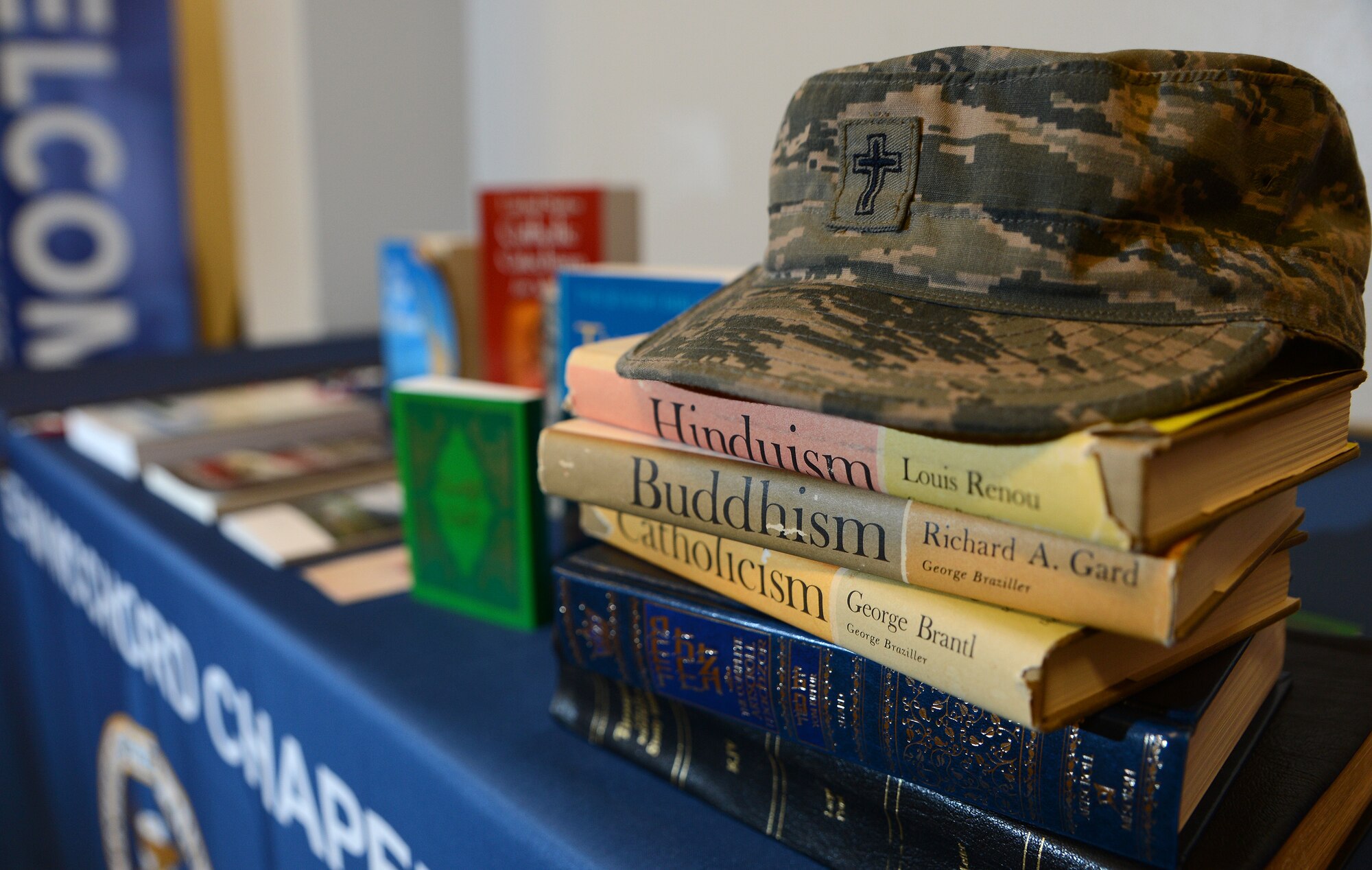 An Air Force Chaplain’s hat is displayed atop religious manuscripts June 22, 2017, at the McChord Chapel Support Center at Joint Base Lewis-McChord, Wash. Chaplains hold different professions of faith but provide an array of religious services and material to Airmen of every faith group. (U.S. Air Force photo/Senior Airman Jacob Jimenez) 