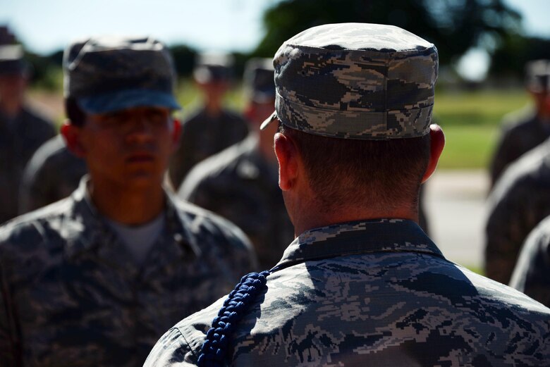 Staff Sgt. Timothy Clutter, 364th Training Squadron military training leader, looks over Airmen during an open ranks inspection. Open ranks inspections are used to ensure that Air Force Instruction 36-2903 is being properly adhered to. (U.S. Air Force photo by Senior Airman Robert L. McIlrath)