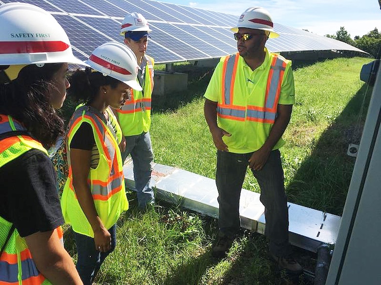 William J. Eggleston III, right, a safety engineer with the U.S. Army Engineering and Support Center, Huntsville's Safety Office, explains a solar array project at Fort Campbell, Kentucky, to summer hire, Lorraine Rosello Del Valle; Erika Cosper, a Pathways Intern; and Jacob Morrison, a summer hire during a recent trip to Fort Campbell. Work on the solar array began in 2012 when the Fort Campbell Directorate of Public Works partnered with the Huntsville Center and the Department of Energy to put together a renewable energy plan for the post.  