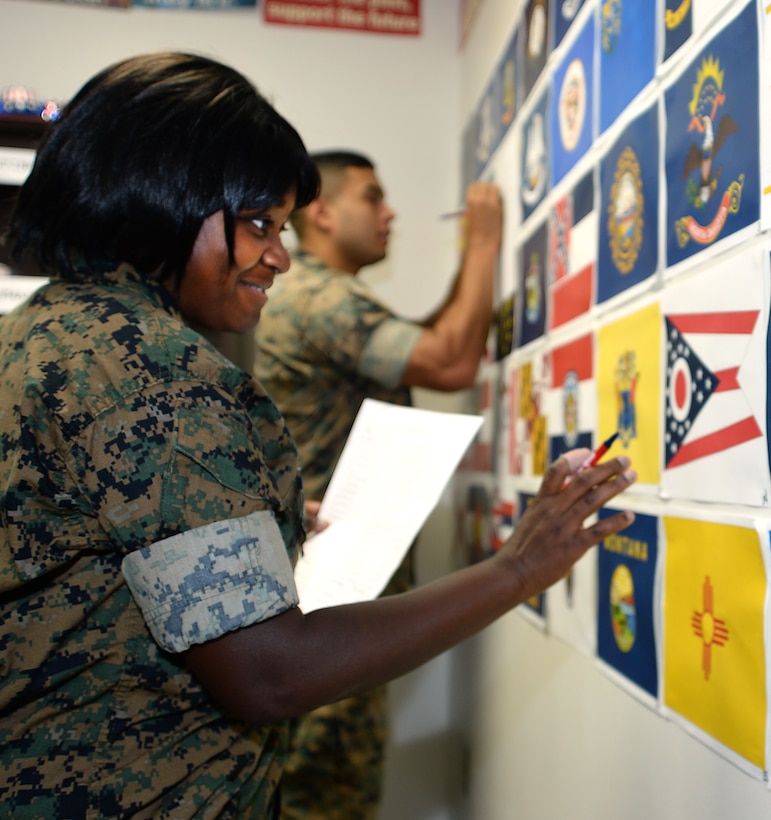 Sgt. Ariana Light, front, supply administration clerk, Logistics Support Division, and Sgt. Joshua Robles, training clerk, Military Operations and Training Division, both with Marine Corps Logistics Base Albany, participate in naming of state flags competition during the installation’s first voting convention, here, June 22.