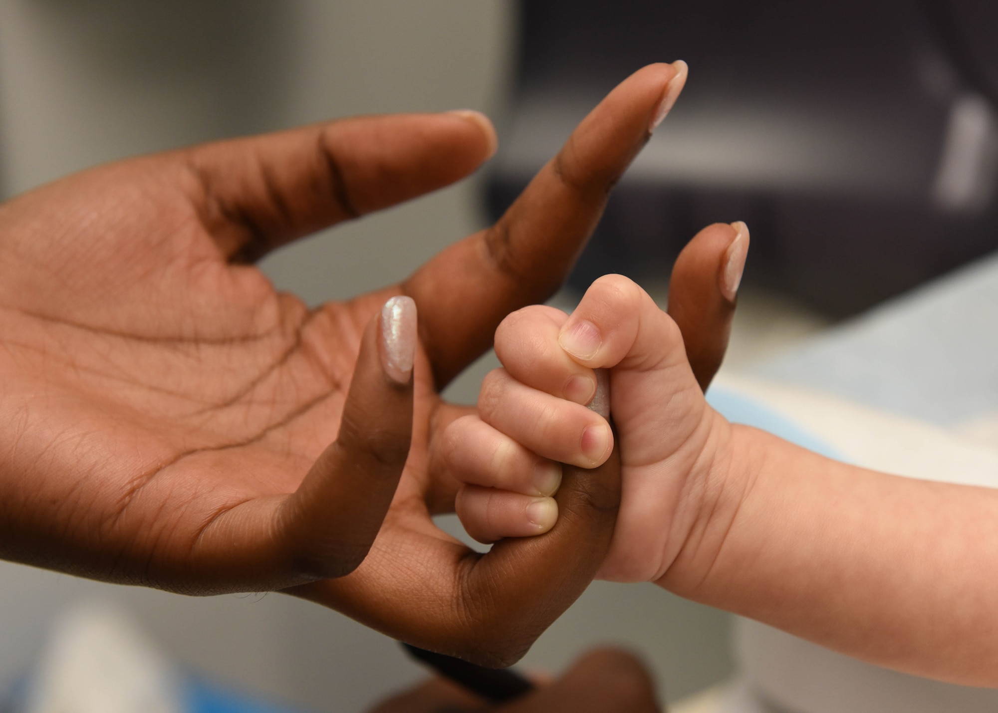 A 19th Medical Operations Squadron pediatric medical technician holds hands with a patient during a check-up June 6, 2017, at Little Rock Air Force Base, Ark. The pediatrics clinic sees children as young as three days to as old as 17 years of age. (U.S. Air Force photo by Senior Airman Mercedes Taylor)