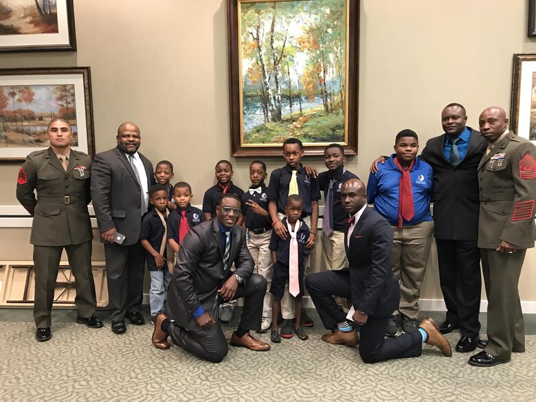 A group of Marines took part in “Ties that Bind,” a mentoring event that teaches young boys to tie a necktie, while forming bonds with some of the community’s most distinguished leaders at the Phoebe Northwest Conference Center in Albany, Ga., June 15.  The annual event, hosted by Phoebe Putney Memorial Hospital’s Network of Trust School Health Program, selects 50 boys, mostly from homes without fathers, and pairs them with 50 local men.  