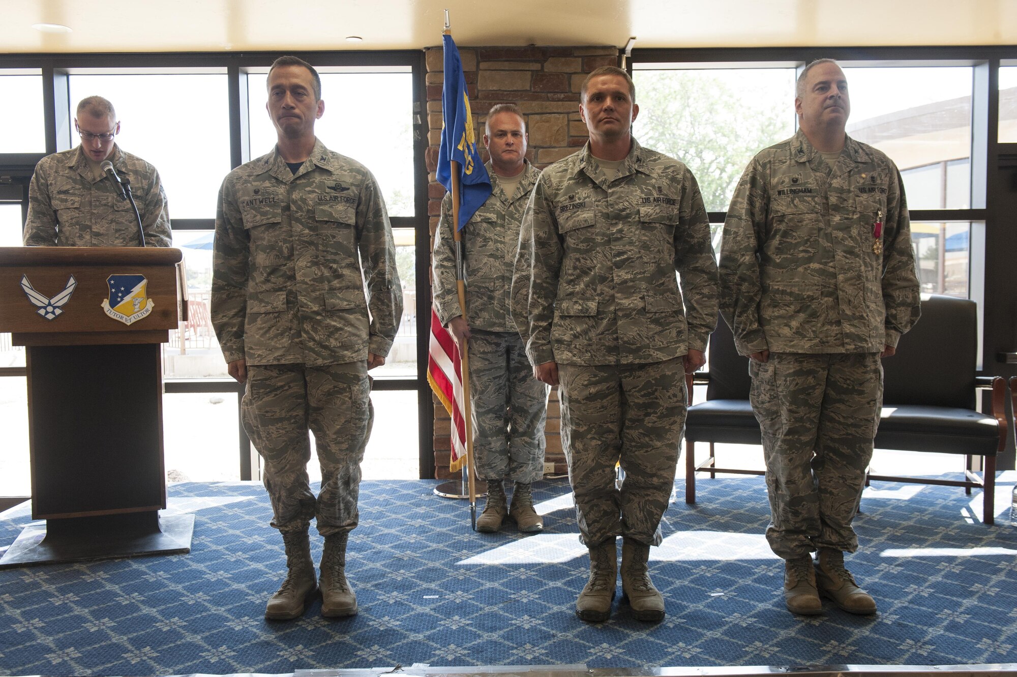 Col. Paul A. Willingham, 49th Medical Group outgoing commander, (right) relinquishes command of the 49th MDG to Col. Paul R. Brezinski (center) by the authority of Col. Houston R. Cantwell, 49th Wing commander (left) at Club Holloman, June 23, 2017. The change of command ceremony is rooted in military tradition and symbolizes the passing of command so all may witness the changing of leadership responsibilities. (U.S. Air Force photo by Airman 1st Class Ilyana A. Escalona)