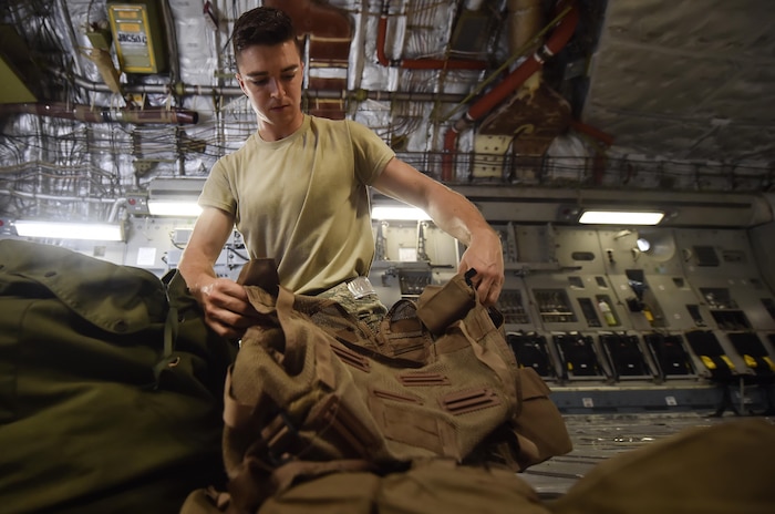 Airman 1st Class Travis Neal, 437th Operations Support Squadron aircrew flight equipment apprentice, packs survival vests and oxygen masks on board a C-17 Globemaster III as part of an inspection at Joint Base Charleston, S.C., June 22. Airmen assigned to the 437th OSS AFE flight ensure that aircrew equipment including helmets, oxygen masks, life rafts, and parachutes are safe and ready for aircrew members to operate. (U.S. Air Force photo by Staff Sgt. Christopher Hubenthal)