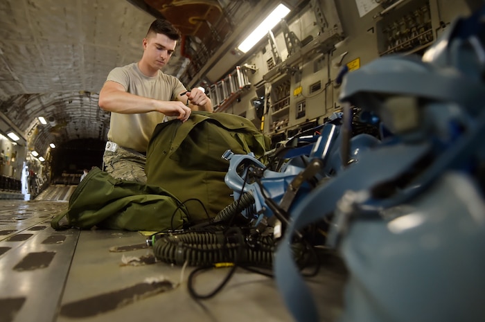 Airman 1st Class Travis Neal, 437th Operations Support Squadron aircrew flight equipment apprentice, packs aircrew equipment on board a C-17 Globemaster III as part of an inspection at Joint Base Charleston, S.C., June 22. Airmen assigned to the 437th OSS AFE flight ensure that aircrew equipment including helmets, oxygen masks, life rafts, and parachutes are safe and ready for aircrew members to operate. 