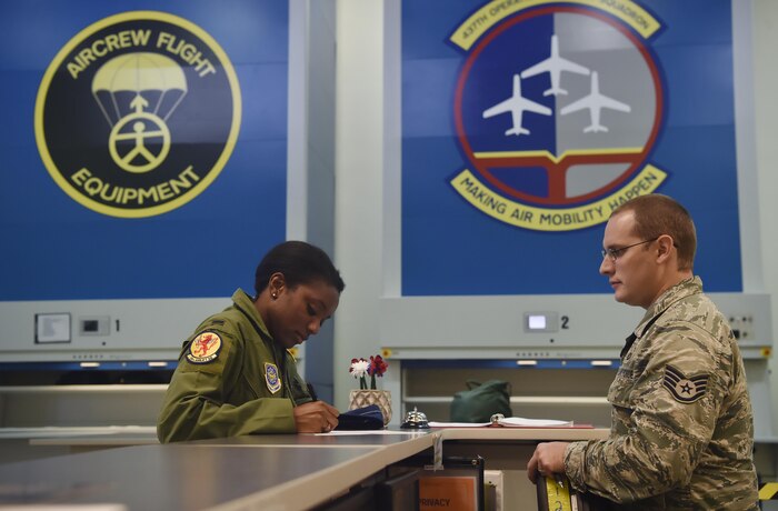 Staff Sgt. Brian Spears, right, 437th Operation Support Squadron aircrew flight equipment NCO in charge of night vision goggle combat survival evader locaters, issues NVGs out to 1st Lt. Ashley Flanagan, 16th Airlift Squadron C-17 Globemaster III pilot, prior to a flying mission at Joint Base Charleston, S.C., June 20. Airmen assigned to the 437th OSS AFE flight ensure that aircrew equipment including helmets, oxygen masks, life rafts and parachutes are safe and ready to operate.