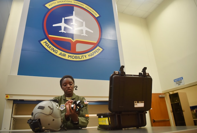 First Lt. Ashley Flanagan, 16th Airlift Squadron C-17 Globemaster III pilot, checks the integrity of a pair of night vision goggles checked out to her by the 437th Operations Support Squadron aircrew flight equipment flight prior to a flying mission at Joint Base Charleston, S.C., June 20. Airmen assigned to the 437th OSS AFE flight ensure that aircrew equipment including helmets, oxygen masks, life rafts and parachutes are safe and ready to operate.