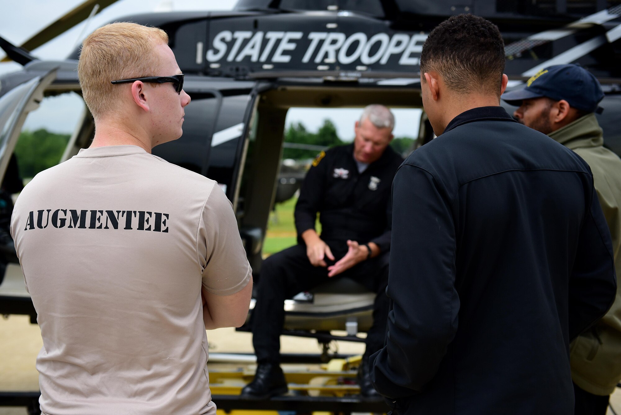 Airman 1st Class Nathan Stripling, 4th Component Maintenance Squadron aerospace propulsion technician (left), and Senior Airman Alex Bertsch, 4th Operations Support Squadron air traffic controller (right), attend a briefing before observing a short haul rescue exercise, July 20, 2017, at the NC State Highway Patrol Precision Driver's Training Facility, Raleigh, North Carolina. Both Airmen are part of the survival, evasion, resistance and escape augmentee program which was initiated at Seymour Johnson Air Force Base. (U.S. Air Force photo by Airman 1st Class Kenneth Boyton)