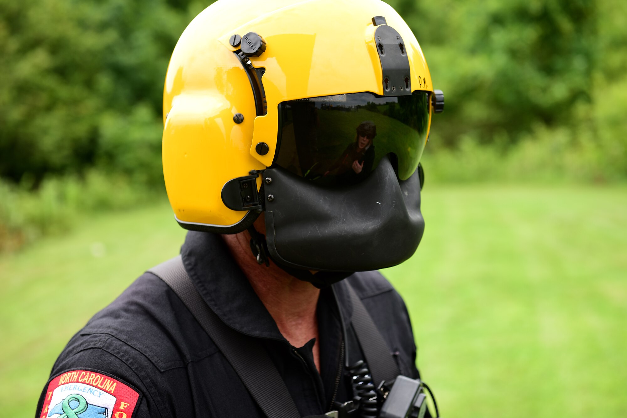 A North Carolina Emergency Management helicopter aquatic rescue team technician prepares to hook up a simulated survivor during a short haul rescue exercise, July 20, 2017, at the NC State Highway Patrol Precision Driver's Training Facility, Raleigh, North Carolina. Survival, evasion, resistance and escape augmentees from Seymour Johnson Air Force Base observed how the HART crew rescued a mannequin and a volunteer, Carly Sherrod, an NCEM intern, multiple times. (U.S. Air Force photo by Airman 1st Class Kenneth Boyton)