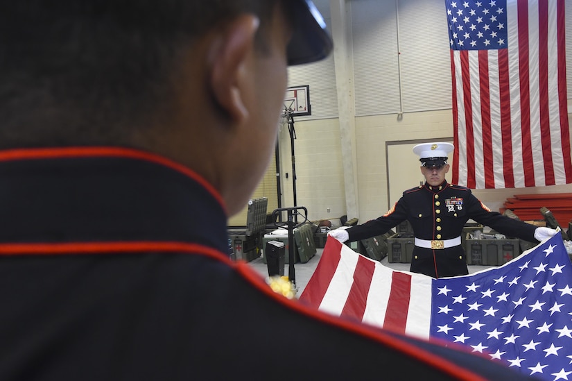U.S. Marine Corps Sgt. Brandon Taylor, left, and Staff Sgt. Robert Swift, right, members of the Combat Logistics Battalion 451 Detachment 3, fold the U.S. flag for an Honor Guard practice session at Joint Base Charleston - Weapons Station, S.C., June 21, 2017. In addition to preparing medical logistics, the unit trains to perform military honors at funerals for any members who have honorably served in the U.S. Marine Corps within a 200-mile radius of the base.