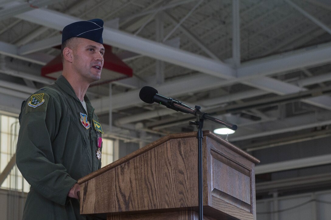 U.S. Air Force Col. Peter Fesler, former 1st Fighter Wing commander, says his final remarks to the 1st FW Airmen before relinquishing command to U.S. Air Force Col. Jason Hinds. The 1st FW has a 100 year heritage that stretches back to World War I. (U.S. Air Force photo by Senior Airman Derek Seifert)