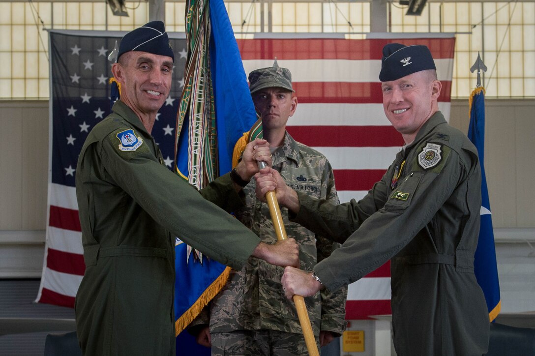 U.S. Air Force Col. Jason Hinds (right), 1st Fighter Wing commander, assumes command of the 1st FW during a change of command ceremony at Joint Base Langley-Eustis, Va., June 23, 2017. Hinds is a command pilot with more than 2,100 flying hours earned primarily in the F-22 Raptor and F-15C Eagle aircraft. (U.S. Air Force photo by Senior Airman Derek Seifert)