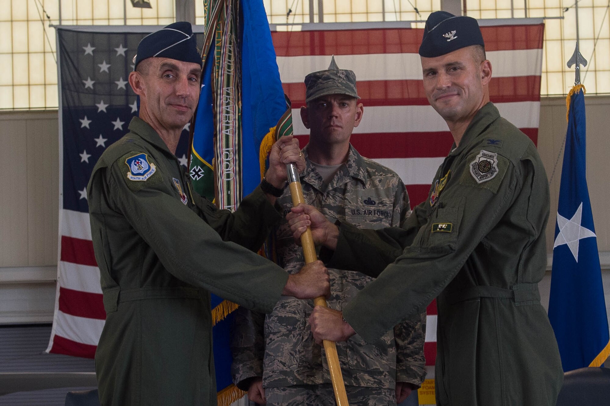 U.S. Air Force Col. Peter Fesler (right), former 1st Fighter Wing commander, relinquishes command of the 1st FW during a change of command ceremony at Joint Base Langley-Eustis, Va., June 23, 2017. The 1st FW is comprised of six squadrons of more than 1,300 members who employ and sustain worldwide rapid deployment of more than 40 F-22 Raptor aircraft. (U.S. Air Force photo by Senior Airman Derek Seifert)