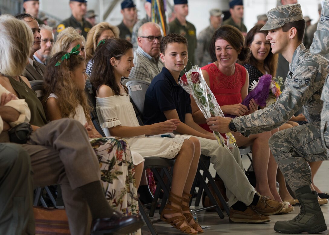 Addison Fesler, daughter of U.S. Air Force Col. Peter Fesler, 1st Fighter Wing outgoing commander, receives a gift during the 1st FW change of command ceremony at Joint Base Langley-Eustis, Va., June 23, 2017. Fesler will continue his career at Peterson Air Force Base in Colorado Springs, Colo., at North American Aerospace Defense Command as the vice director of operations. (U.S. Air Force photo/Staff Sgt. J.D. Strong II)