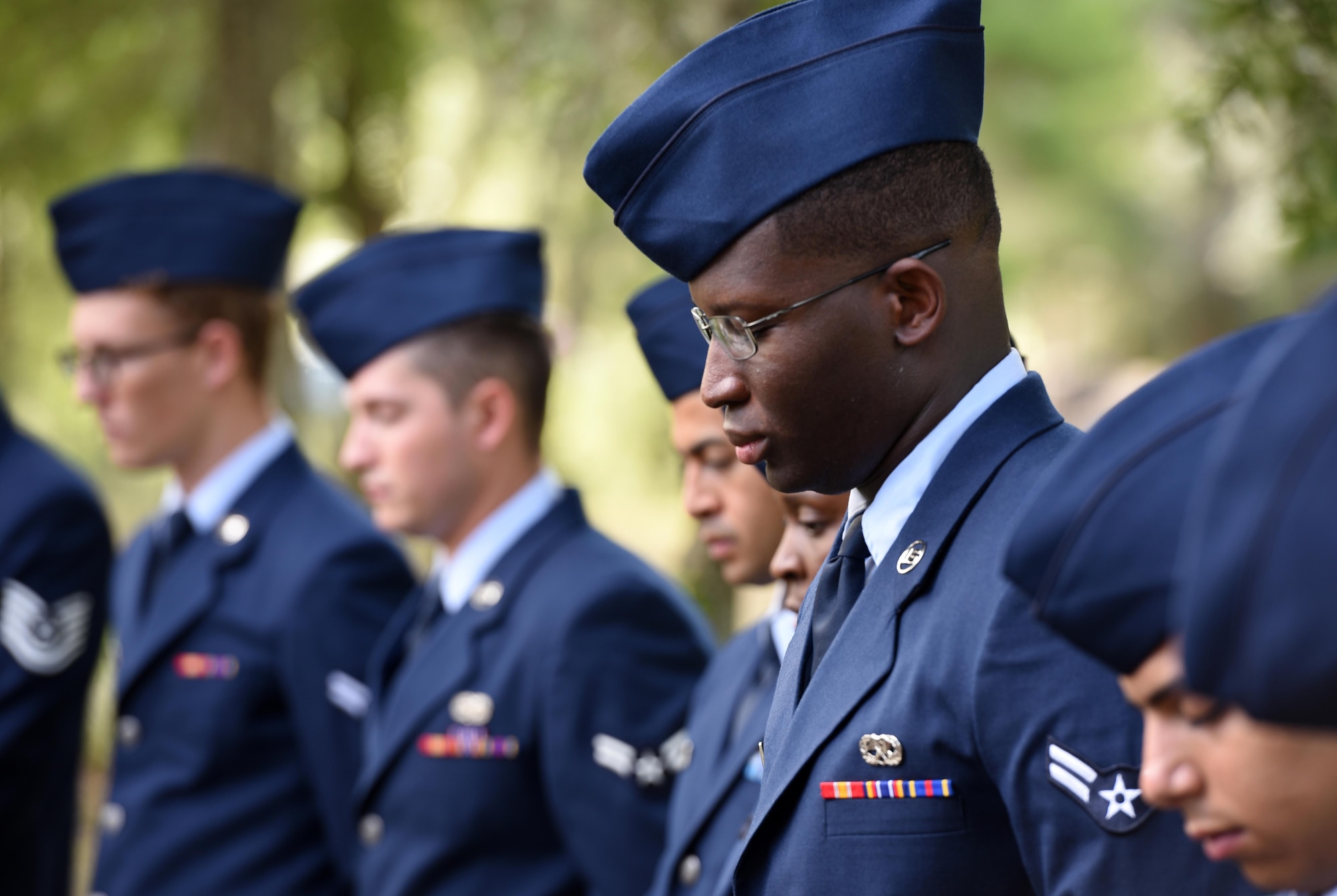Airmen from the 33rd Fighter Wing bow their heads during the invocation for the Khobar Towers 21st Anniversary Wreath Laying Ceremony June 23, 2017, at Eglin Air Force Base, Florida. On June 25, 1996, a bomb was detonated near the Khobar Towers housing complex in Dhahran, Saudi Arabia. Nineteen Airmen were killed and more than 400 U.S. and international military and civilians were injured in the blast.  Of the 19 killed, 12 were Nomads. Each year the 33 FW holds a ceremony in remembrance of that day. (U.S. Air Force photo by Staff Sgt. Peter Thompson)