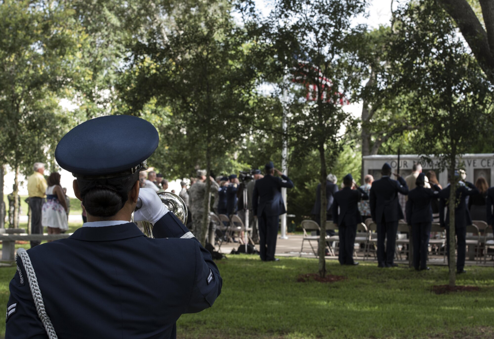 A member of the base Honor Guard plays Taps during the Khobar Towers 21st Anniversary Wreath Laying Ceremony June 23, 2017, at Eglin Air Force Base, Florida. On June 25, 1996, a bomb was detonated near the Khobar Towers housing complex in Dhahran, Saudi Arabia. Nineteen Airmen were killed and more than 400 U.S. and international military and civilians were injured in the blast.  Of the 19 killed, 12 were Nomads. The Nomad Each year the 33 FW holds a ceremony in remembrance of that day. (U.S. Air Force photo by Staff Sgt. Peter Thompson)