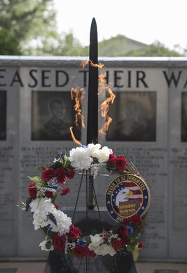 A wreath is placed in front of the burning sword at the Nomad Memorial during the Khobar Towers 21st Anniversary Wreath Laying Ceremony June 23, 2017, at Eglin Air Force Base, Florida. On June 25, 1996, a bomb was detonated near the Khobar Towers housing complex in Dhahran, Saudi Arabia. Nineteen Airmen were killed and more than 400 U.S. and international military and civilians were injured in the blast.  Of the 19 killed, 12 were Nomads. Each year the 33 FW holds a ceremony in remembrance of that day. (U.S. Air Force photo by Staff Sgt. Peter Thompson)